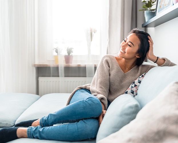 Woman smiling while relaxing at home